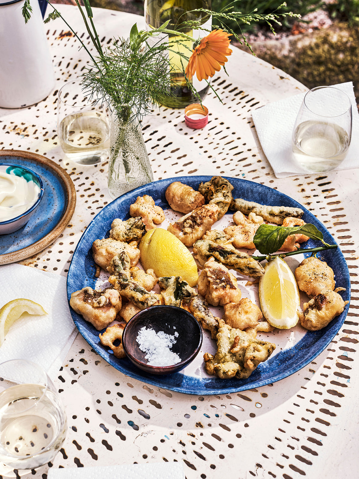 Anglesey salt and pepper fritto misto on a blue plate, outdoors